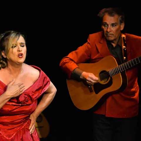 La chanteuse en robe rouge et le guitariste en veste rouge
